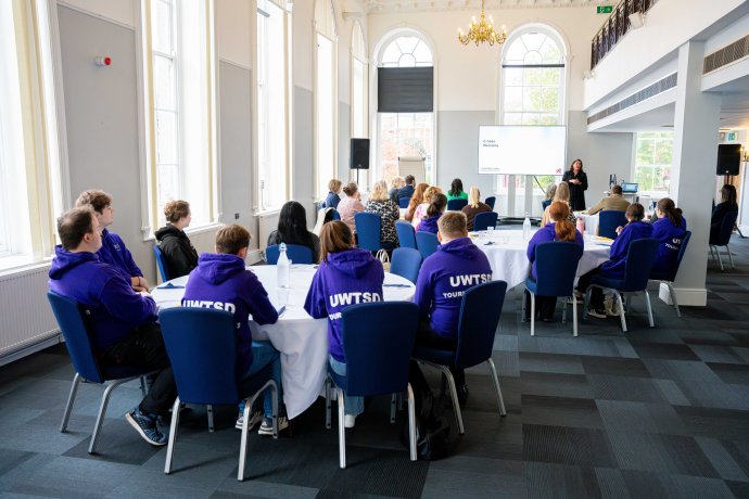 image of Heledd Williams giving a talk to students and staff