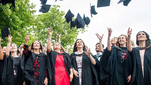 a group of students throwing hats in the air