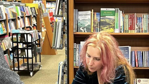 Image of Carly Holmes signing one of her books