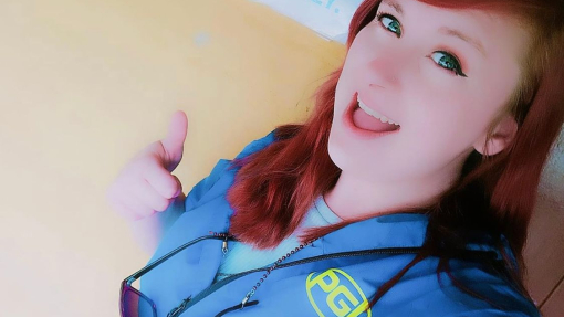 woman taking selfie with 'PGL' written on her shirt