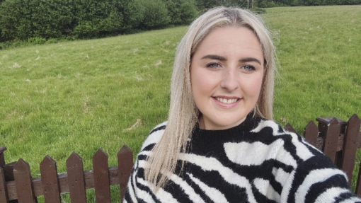 Woman taking selfie with greenery in the background
