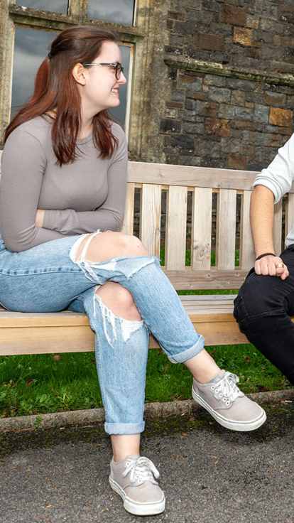 two students sitting on a bench
