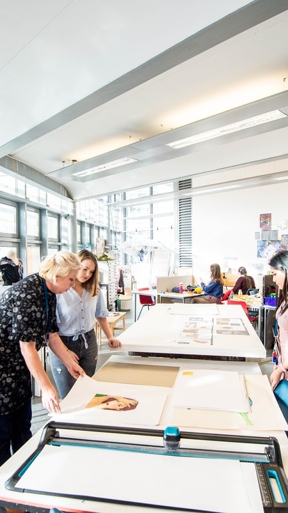 students in a light classroom doing art