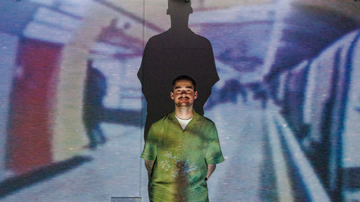 photography summer show exhibition man in front of his display