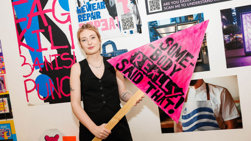 student in front of work display