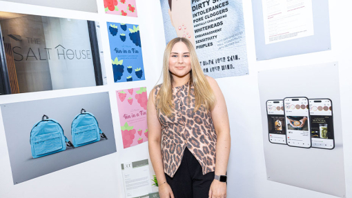 student in front of work display