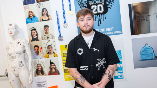 student in front of work display