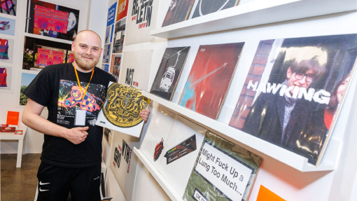 student in front of work display