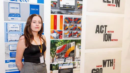 student in front of work display
