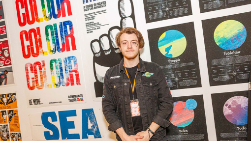 student in front of work display