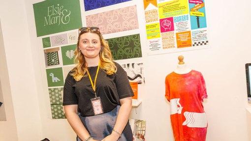 student in front of work display