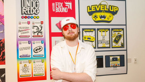 student in front of work display