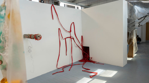 red ribbon merging out of a wall