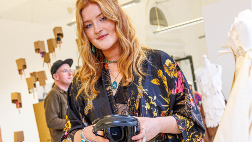 woman holding headphones in the exhibition