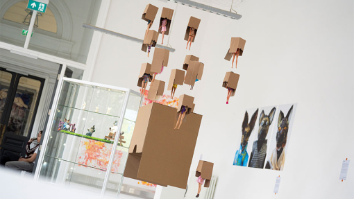 art and design of barbie dolls hanging from a box
