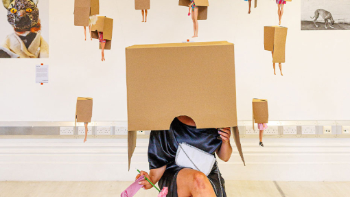 art and design of barbie dolls hanging from a box