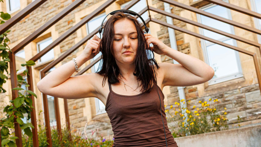 a female playing music on a dj decks