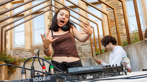 a female playing music on a dj decks