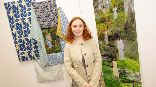 student in front of work display