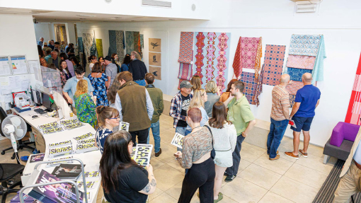 crowed of people looking at the surface design work
