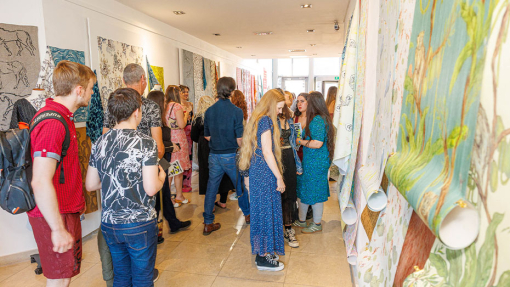 crowed of people looking display of work
