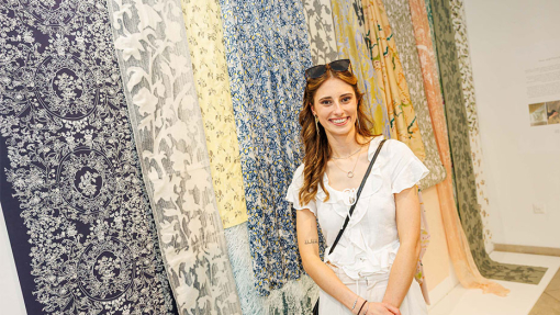 student in front of work display