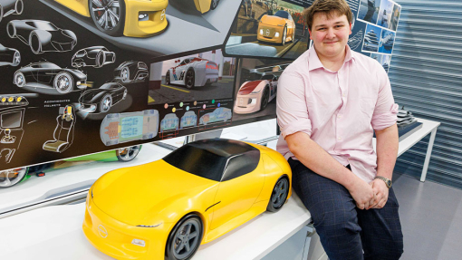 Automotive and Transport Design Summer Show Exhibition student next to work