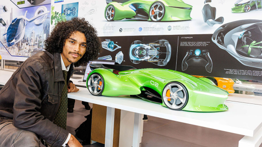 Automotive and Transport Design Summer Show Exhibition student next to work