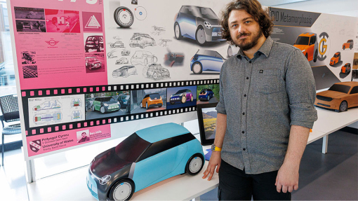 Automotive and Transport Design Summer Show Exhibition student next to work