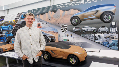 Automotive and Transport Design Summer Show Exhibition student next to work