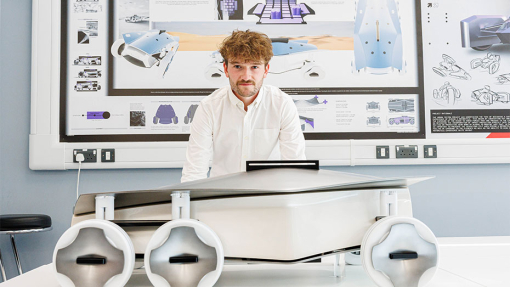 Automotive and Transport Design Summer Show Exhibition student next to work