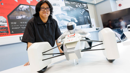 Automotive and Transport Design Summer Show Exhibition student next to work