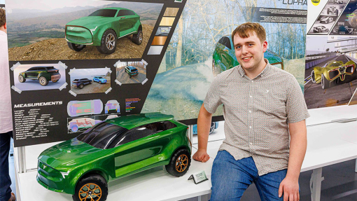 Automotive and Transport Design Summer Show Exhibition student next to work