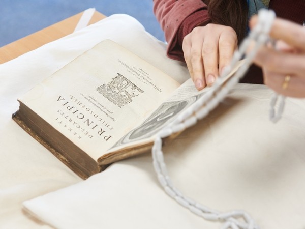 Student handling an old book