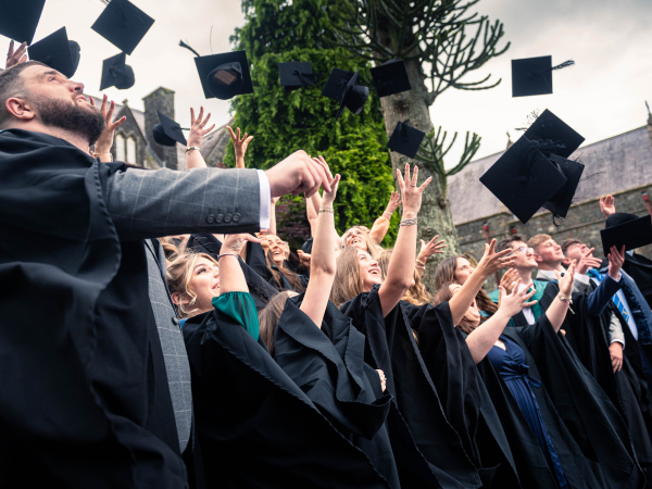Students graduating throwing their caps into the air