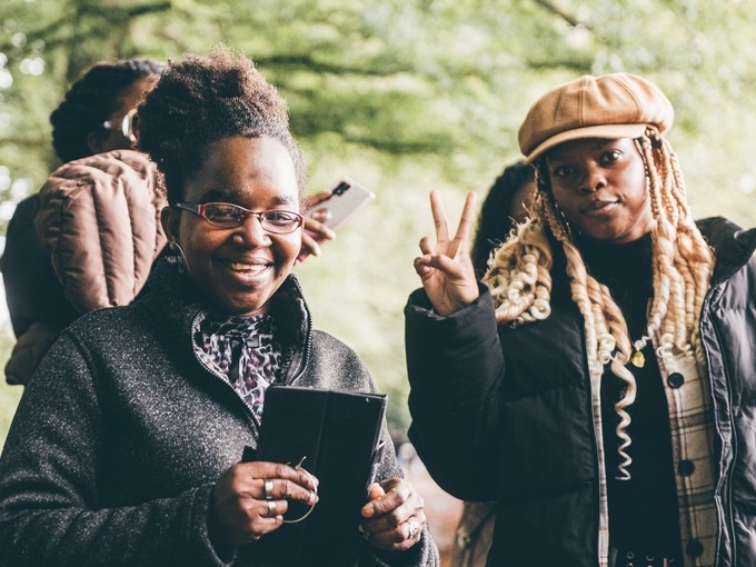 students smiling with trees in the background