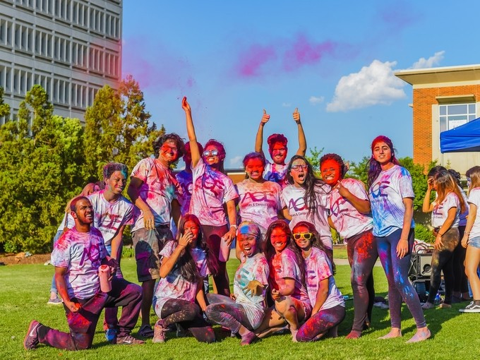 Image of students marking Holi covered in brightly coloured powder