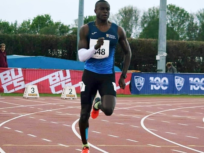 David Migliorati N’Doua sprinting on a running track.
