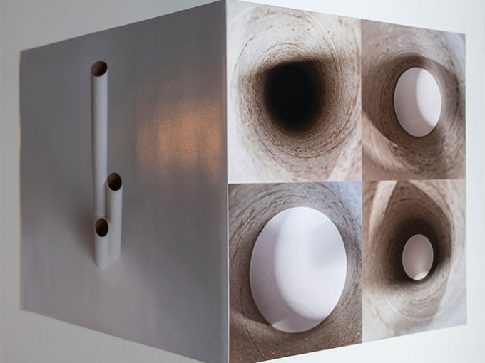 string art on a wall with tubes