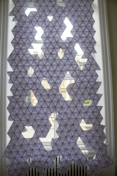 Image of 3D artwork against a window. 