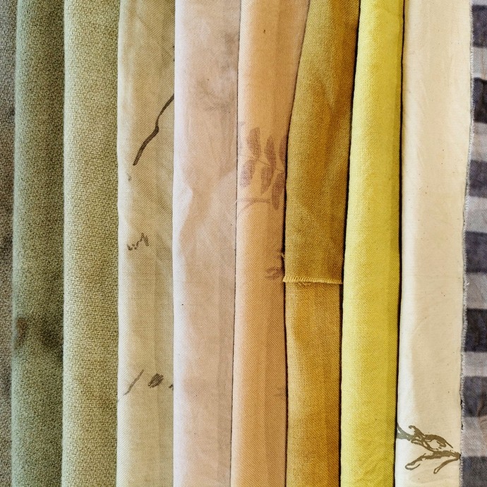 Fabric samples in low-key greens, pinks, and yellows. 