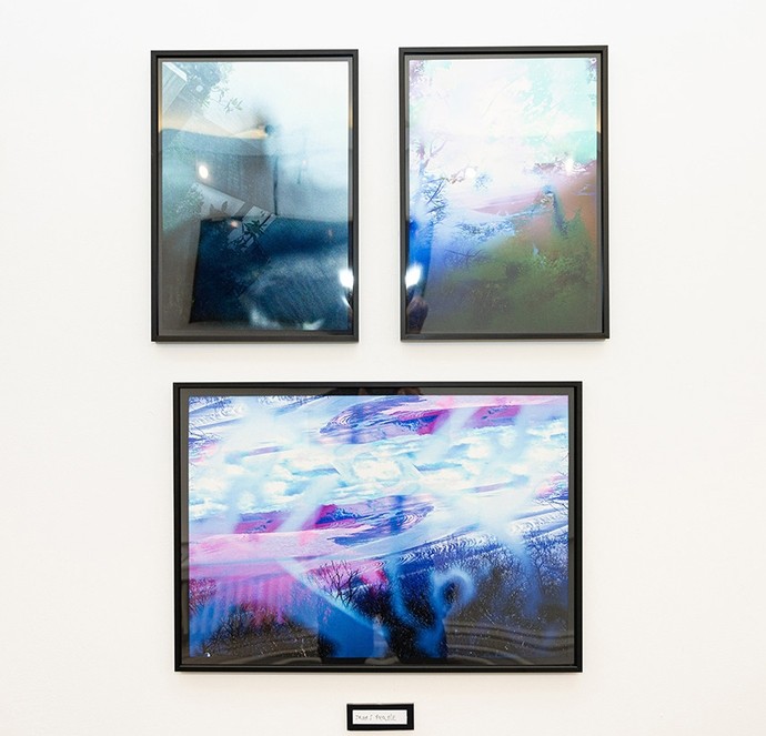 Three photographic framed images overlaid with planes of blue light. 
