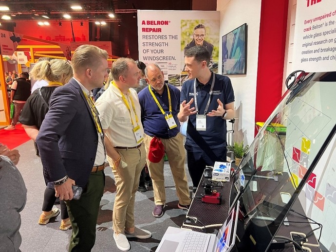 Jordan Jenkins from UWTSD discussing the research with delegates on the trade stand at the Belron conference in Lisbon