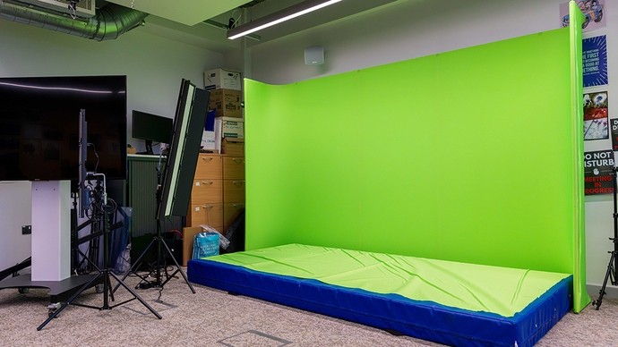 A thick green mat in front of a green screen. 