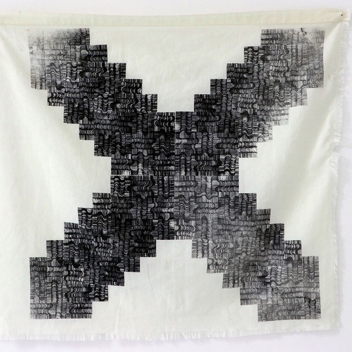 A charcoal-coloured x-shaped cross filled with a complex pattern; it has been printed onto a plain piece of beige cloth.