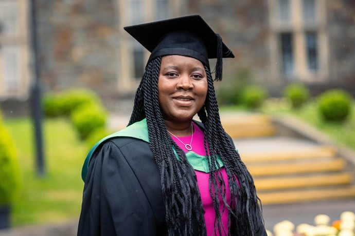 Eunice Moyo wearing her cap and gown ready for graduation 