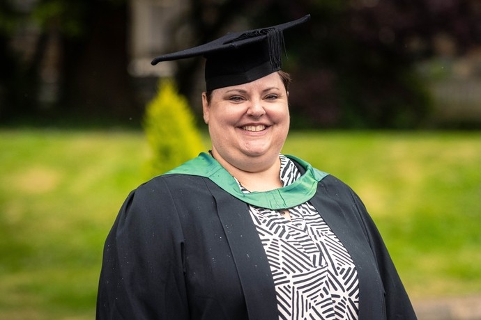 An image of Angie Kelly wearing her cap and gown 