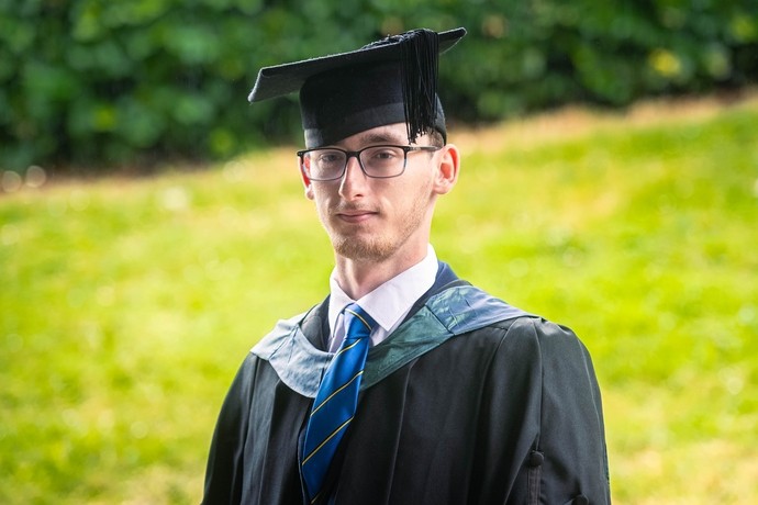 An image of Dafydd Millns in his cap and gown 