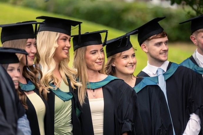 Students in graduation gowns on Carmarthen campus