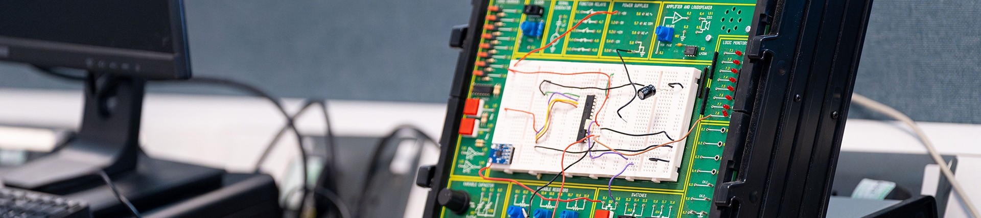 A close-up on the circuit board and wires of a virtual instrument panel.